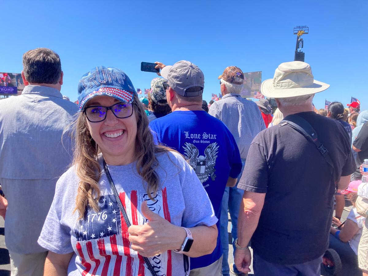 Wearing a rhinestone "TRUMP" cap, Lana Bento, 52, of Hewitt, Texas, signals her support for former President Donald Trump as he holds a rally in Waco, Texas, on March 25, 2023. (Janice Hisle/The Epoch Times)