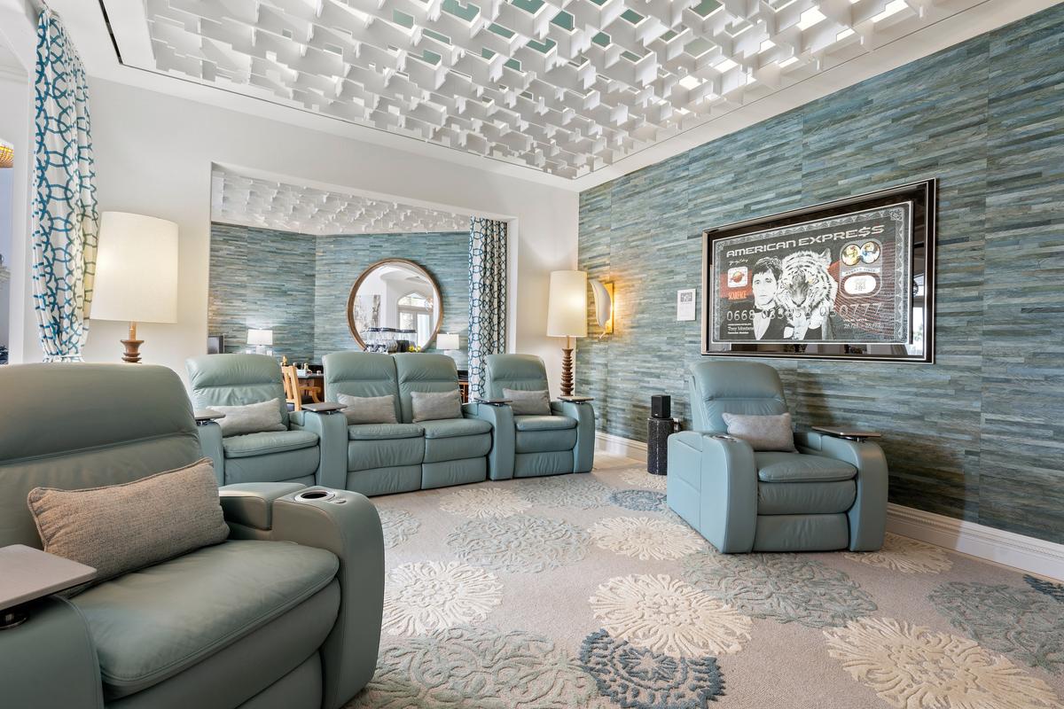 The home’s theater features comfortable seating arranged to ensure everyone has an unobstructed views of the screen, with a wet bar at the rear to serve drinks and snacks. (Courtesy of James Northen / ONE Sotheby's International Realty)