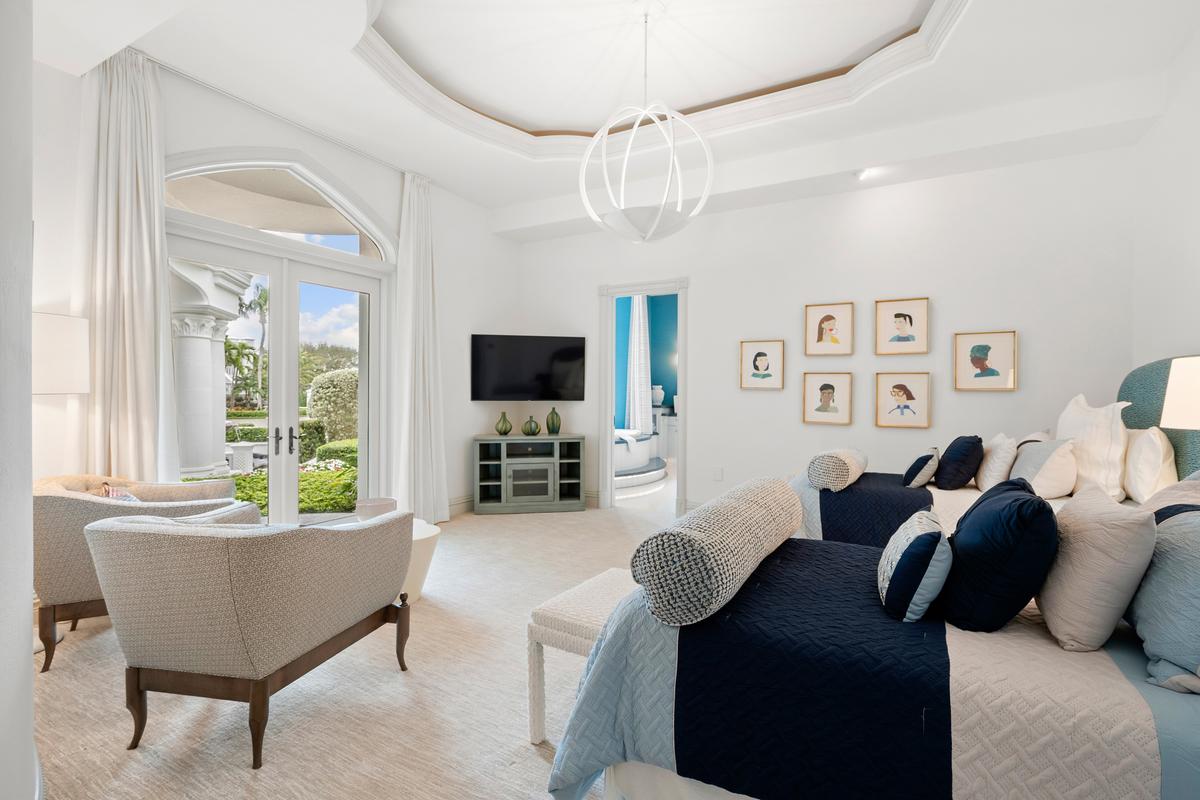 The main residence’s bedrooms all feature soaring ceilings with custom crown molding, resort-style bathrooms, and large windows to bring in natural light. (Courtesy of James Northen / ONE Sotheby's International Realty)