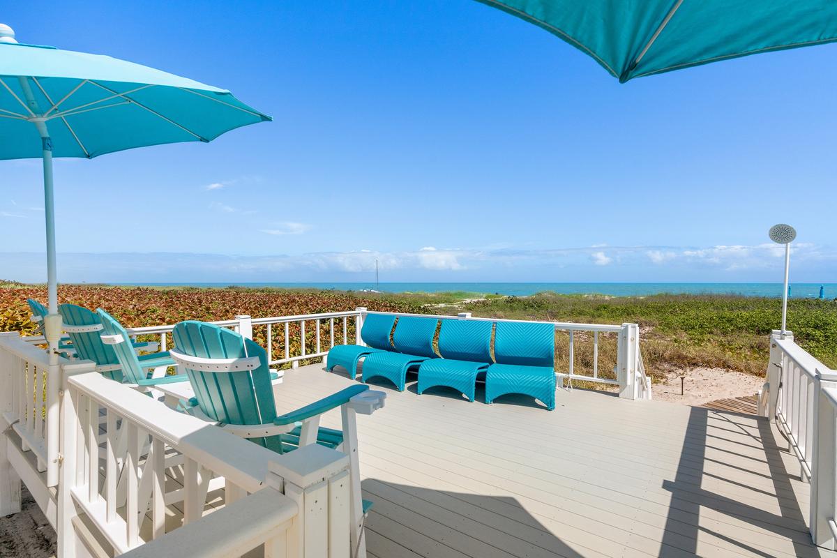 The private deck on the beach frontage provides easy access to the water, and is an ideal setting to enjoy the refreshing ocean breeze, day or night. (Courtesy of James Northen / ONE Sotheby's International Realty)