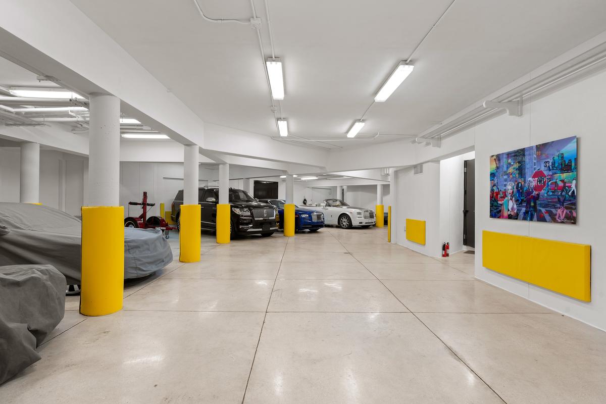 The air-conditioned garage can accommodate up to 14 vehicles, all safe and secure from the salty beach climate. (Courtesy of James Northen / ONE Sotheby's International Realty)