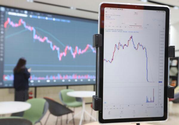 A screen (R) shows the falling values of the Luna cryptocurrency, at a cryptocurrency exchange in Seoul, South Korea, on May 27, 2022. (Ryu Hyo-lim/Yonhap via AP)