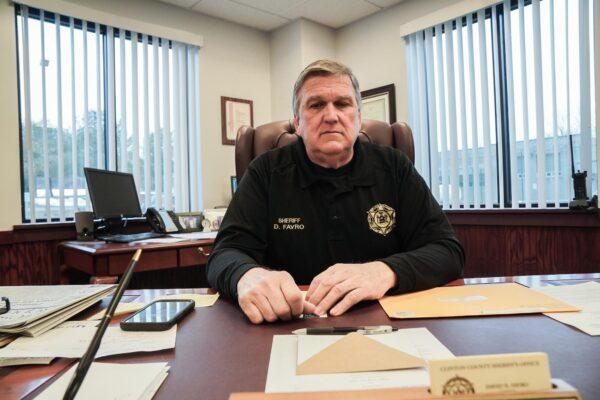 Clinton County, N.Y., Sheriff David Favro sits at his desk on March 23, 2023. (Allan Stein/The Epoch Times)