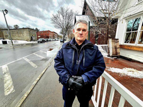 Woodstock, Vt., Police Chief Robbie Blish stands outside a local business on March 24, 2023. (Allan Stein/The Epoch Times)
