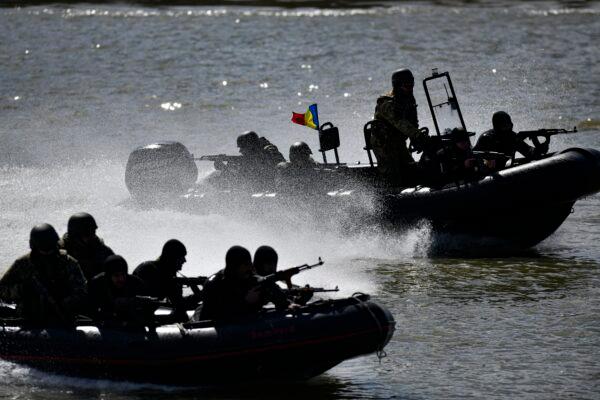 Romanian naval commandos sail in speedboats on the river Danube during a Romanian Navy led exercise outside Mahmudia, Romania, on March 30, 2023. (Alexandru Dobre/AP Photo)