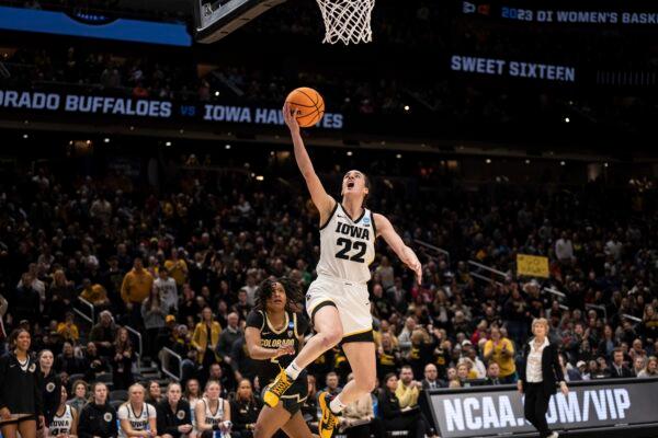 Iowa guard Caitlin Clark (22) goes up for a layup against Colorado guard Tameiya Sadler during the second half of a Sweet 16 college basketball game of the NCAA tournament in Seattle on March 24, 2023. (Stephen Brashear/AP Photo)