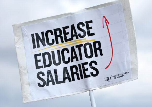 A sign reads 'Increase Educator Salaries' as Los Angeles Unified School District (LAUSD) workers and supporters rally in Los Angeles State Historic Park on the last day of a strike over a new contract in Los Angeles on March 23, 2023. (Mario Tama/Getty Images)