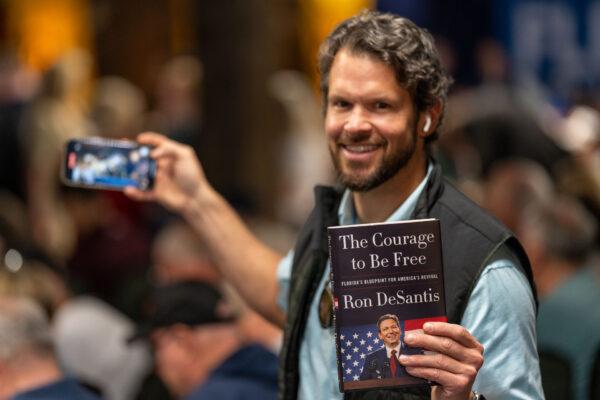 A fan with his copy of Florida Gov. Ron DeSantis's book "The Courage To Be Free" at a book tour event in Smyrna, Ga. on March 30, 2023. (Phil Mistry/The Epoch Times)