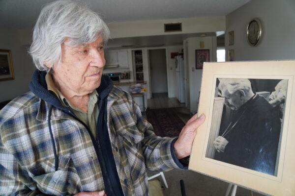 George Ilinsky holds a picture of his late father, Andrew, on March 21, 2023. (Allan Stein/The Epoch Times)