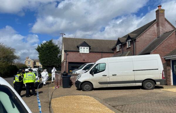 Police and forensics officers at the scene in The Row in Sutton, near Ely, Cambridgeshire, on Mar. 30, 2023. (PA Media)