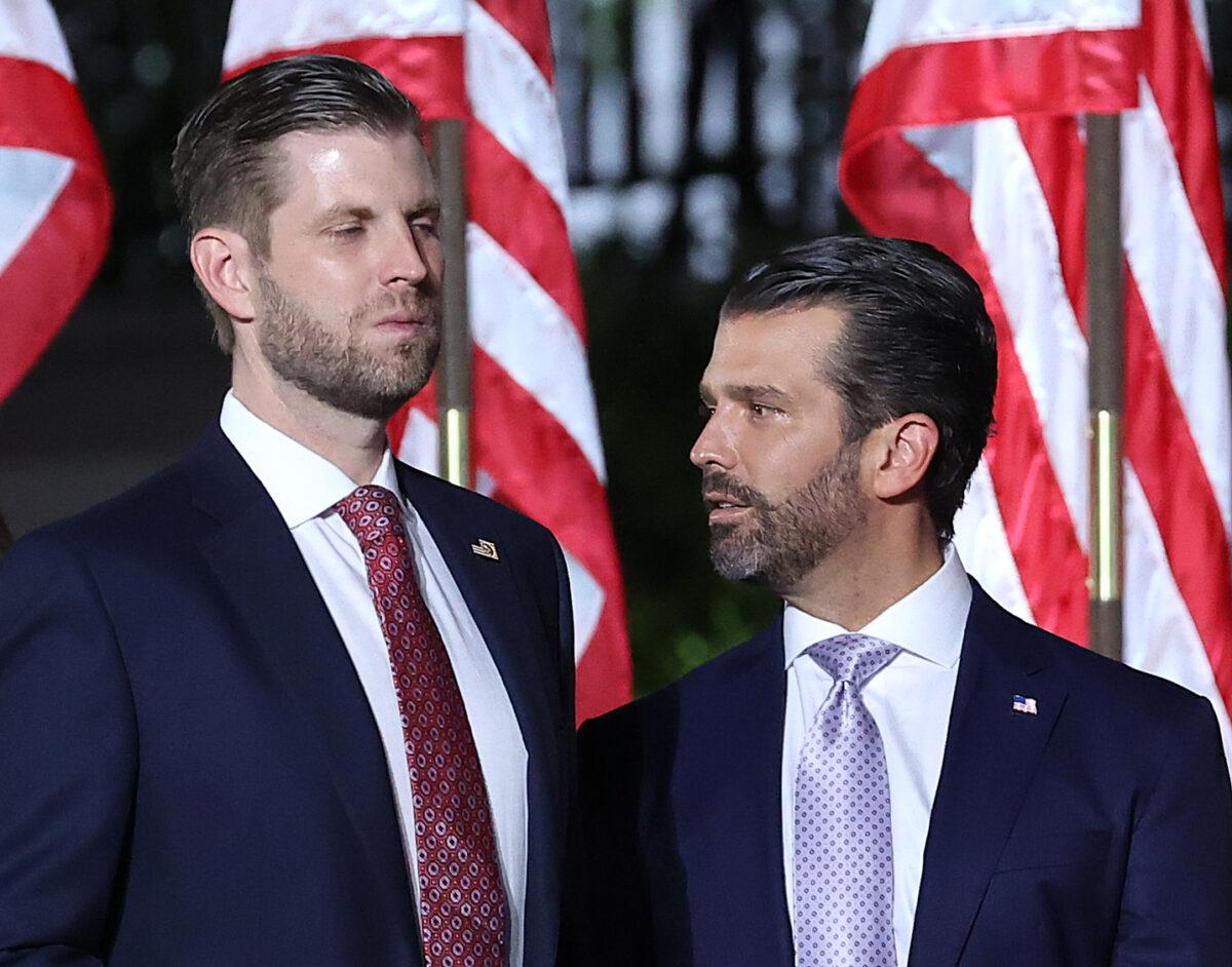 Donald Trump Jr. (R) and Eric Trump look on as then President Donald Trump prepares to deliver his acceptance speech for the Republican presidential nomination on the South Lawn of the White House, in Washington, on Aug. 27, 2020. (Chip Somodevilla/Getty Images)