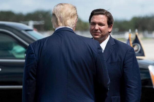 President Donald Trump is greeted by Florida Gov. Ron DeSantis at Southwest Florida International Airport on Oct. 16, 2020. (Brendan Smialowski /AFP via Getty Images)