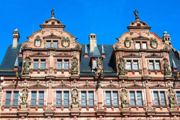 The top of Friedrichsbau’s façade is adorned with stone sculptures of the Wittelsbach family that were designed by architect Johannes Soch and sculptor Sebastian Goetz. The highest sculptures depict the “fathers” of the Wittelsbach line: Charlemagne and Otto von Wittelsbach. Just below are sculptures of select representatives of the Wittelsbach family, such as Prince-Elector Ruprecht I and Prince-Elector Ottheinrich. The third row represents emperors and kings descending from the House of Wittelsbach. The sculptures on the façade are replicas from about 1900; the original ones are found inside Friedrich’s Wing. (<a href="https://www.shutterstock.com/g/Fabian+Junge">Fabian Junge</a>/<a href="https://www.shutterstock.com/image-photo/heidelberger-friedrichsbau-castle-german-schloss-heidelberg-1675156483">Shutterstock</a>)
