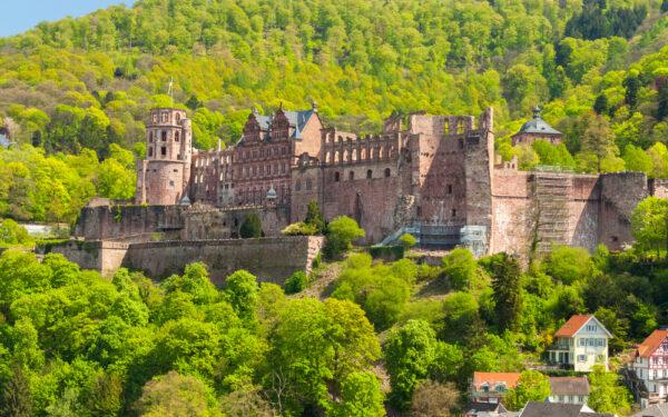 The ruins of Heidelberg Castle are set against the green forest of Königstuhl Hill. The façade of the complex features red sandstone from the Neckar Valley. The castle has a collection of buildings in partial disrepair, with the most notable ones being examples of Renaissance architecture.  (<a href="https://www.shutterstock.com/g/TANAWATPortfolio">1989 studio</a>/<a href="https://www.shutterstock.com/image-photo/close-view-ruin-heidelberg-castle-germany-417646768">Shutterstock</a>)