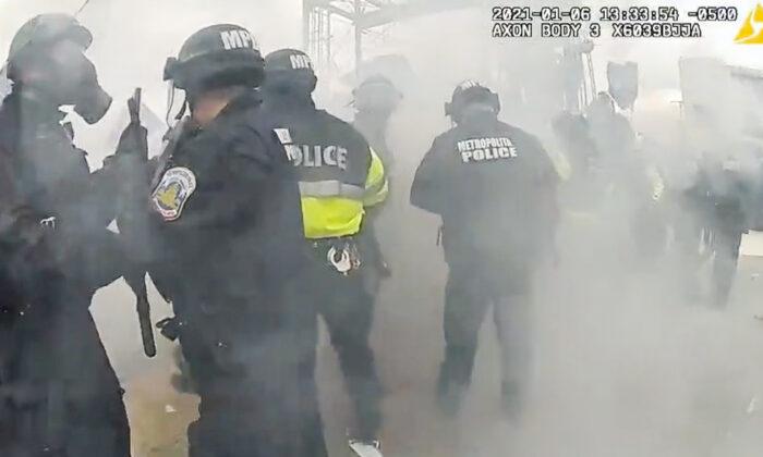 Police officers scatter after an MPD officer misfired a tear gas shell that landed in their midst on Jan. 6, 2021. (Metropolitan Police Department/Screenshot via The Epoch Times)