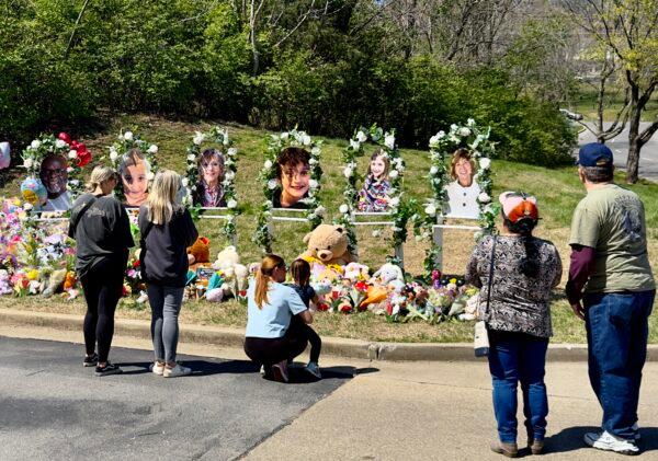 Mourners observe the makeshift memorial at The Covenant School in the Green Hills neighborhood of Nashville on March 31, 2023, four days after six were killed at the school in a shooting. (Chase Smith/The Epoch Times)