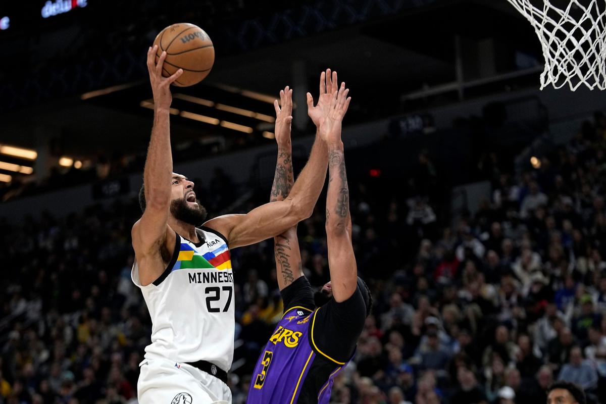 Minnesota Timberwolves center Rudy Gobert shoots while defended by Los Angeles Lakers forward Anthony Davis during the first half of an NBA basketball game in Minneapolis, on March 31, 2023. (Abbie Parr/AP Photo)
