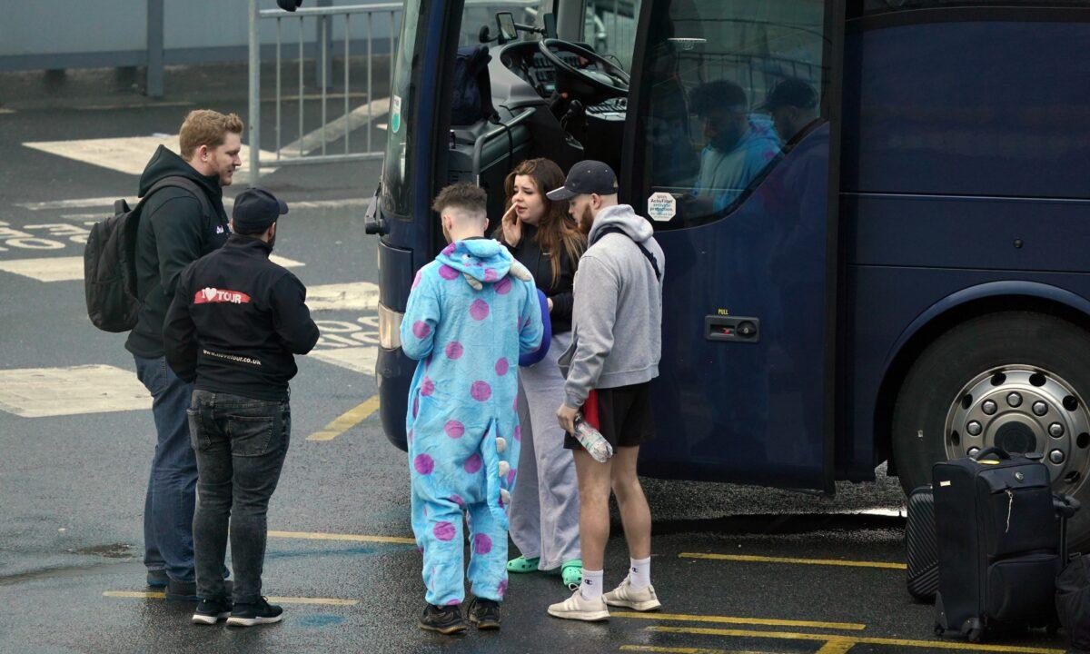 Passengers by their coach at the Port of Dover in Kent, England, on April 1, 2023. (Gareth Fuller/PA)
