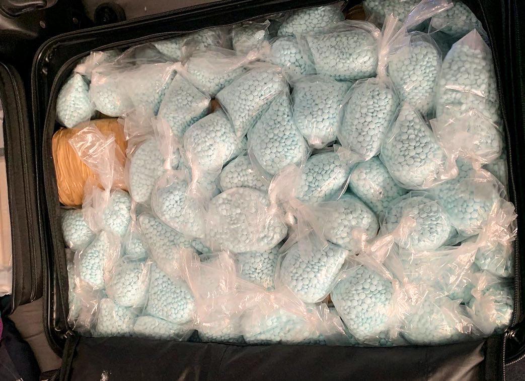 A suitcase full of bags of fentanyl pills seized by DEA Los Angeles. (Courtesy of DEA Los Angeles)