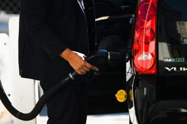 A customer pumps gasoline into a sport utility vehicle (SUV) at a Shell gas station in the Chinatown neighborhood of Los Angeles, Calif., on Feb. 17, 2022. (Patrick T. Fallon/AFP via Getty Images)