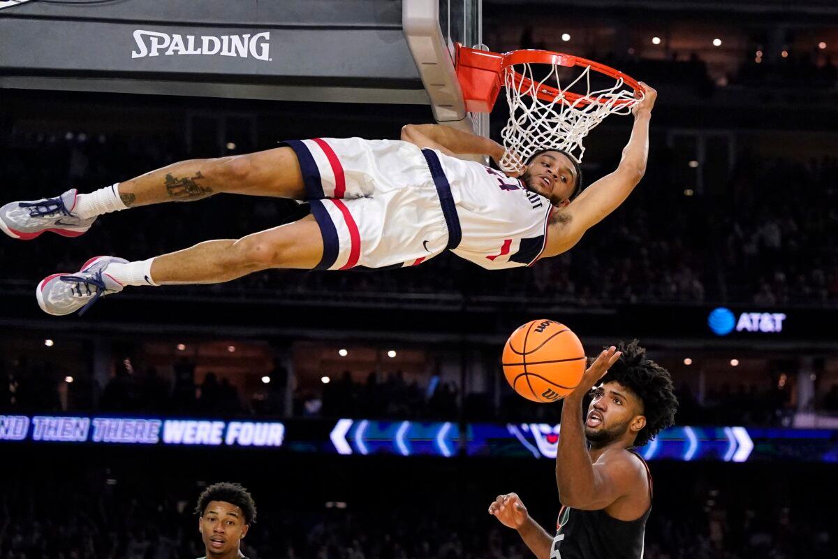 Connecticut guard Andre Jackson Jr. dunks the ball over Miami forward Norchad Omier, right, during the second half of a Final Four college basketball game in the NCAA Tournament in Houston on April 1, 2023. (David J. Phillip/AP Photo)