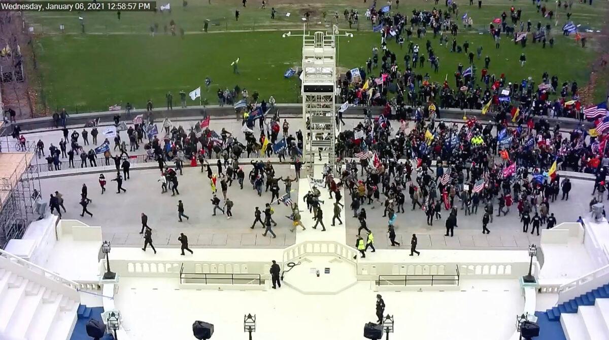 Crowds breach the police line on the west front of the U.S. Capitol, as captured by a Capitol Police security camera. (U.S. Capitol Police/Screenshot via The Epoch Times)