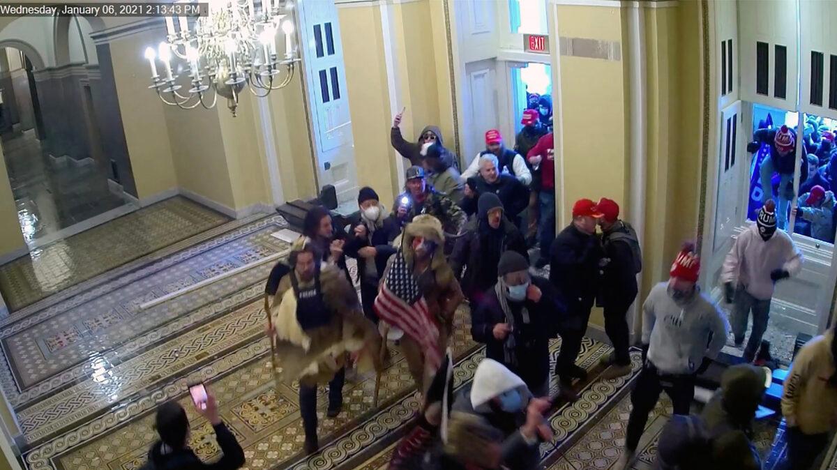 Protesters breach the Senate Wing doors at the U.S. Capitol on Jan. 6, 2021. (U.S. Capitol Police/Screenshot via The Epoch Times)
