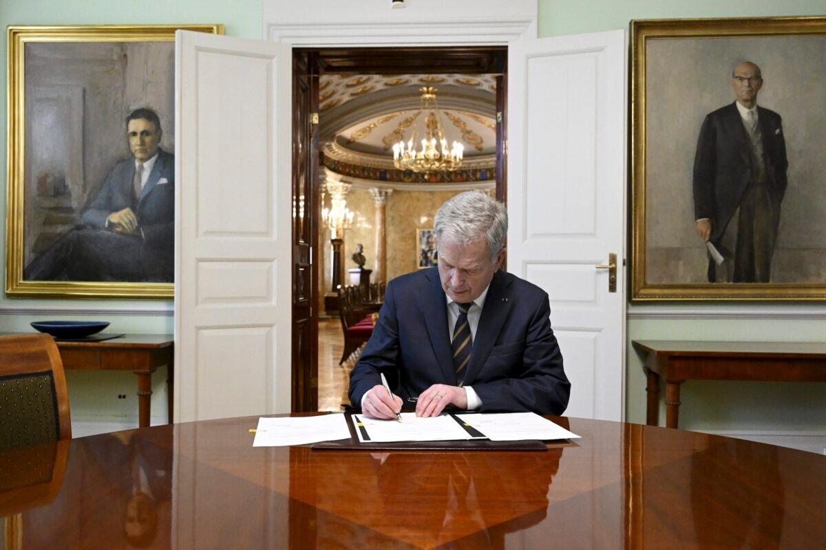 Finland's President Sauli Niinisto signs Finland's national Nato legislation in Helsinki, Finland, on March 23, 2023. The Finnish president has signed into laws the required legal amendments needed for membership in the military alliance. (Markku Ulander/Lehtikuva via AP)