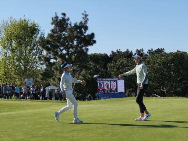 Americans Lucy Li (L), and Nelly Korda (R) embrace upon finishing their final round on the 18th green, at the DIO Implant LA Open, at Palos Verdes Golf Club in Palos Verdes Estates, Calif., on April 2, 2023. (Nhat Hoang/The Epoch Times)