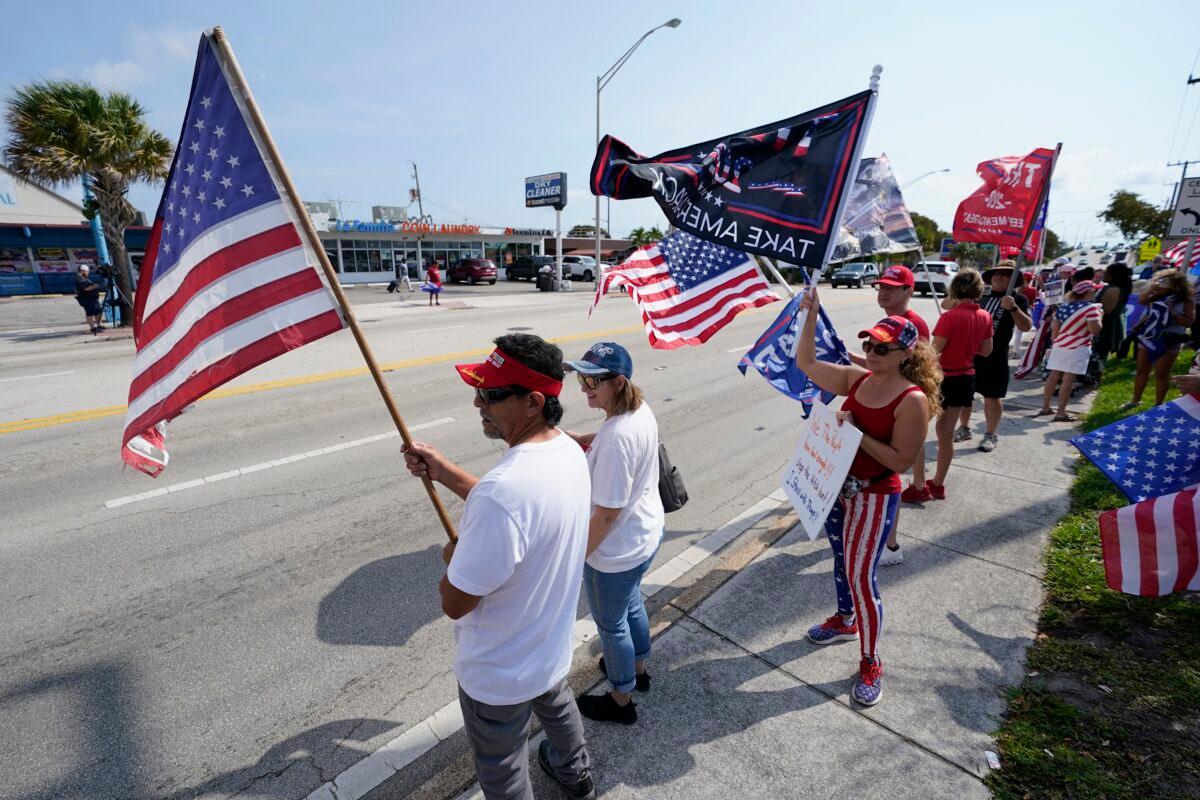 Supporters of former President Donald Trump wave flags and cheer at a rally in West Palm Beach, Fla., on April 3, 2023. (Wilfredo Lee/AP Photo)
