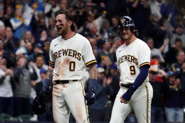Milwaukee Brewers' Brice Turang (0) reacts with Brian Anderson (9) after hitting a grand slam during the fifth inning of a baseball game against the New York Mets in Milwaukee on April 3, 2023. (Aaron Gash/AP Photo)