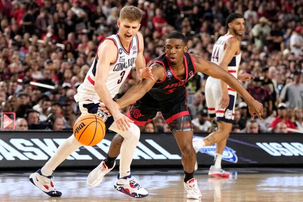 San Diego State guard Lamont Butler (5) vies for the ball with Connecticut guard Joey Calcaterra (3) during the first half of the men's national championship college basketball game in the NCAA Tournament in Houston on April 3, 2023. (Brynn Anderson/AP Photo)