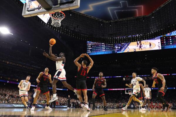 Adama Sanogo (21) of the Connecticut Huskies drives to the basket against Keshad Johnson (0) of the San Diego State Aztecs during the second half during the NCAA Men's Basketball Tournament National Championship game at NRG Stadium in Houston on April 3, 2023. (Carmen Mandato/Getty Images)