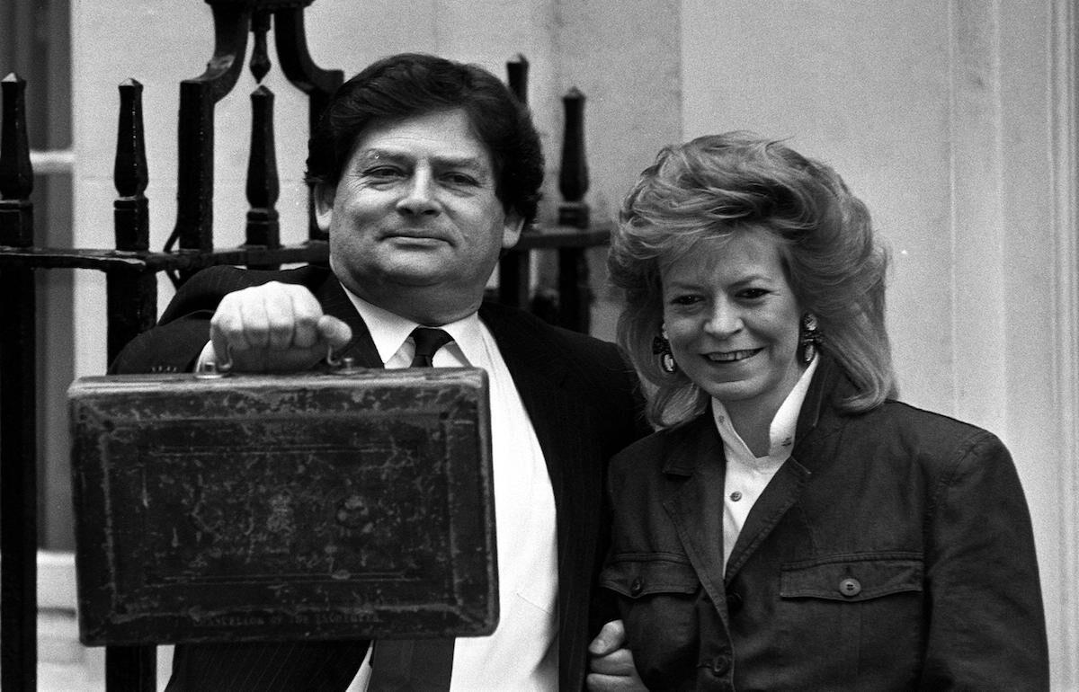 Chancellor of the Exchequer Nigel Lawson holding up his Budget box with his wife Therese before he set off to the Commons to present the budget. on March 14, 1989. (PA)