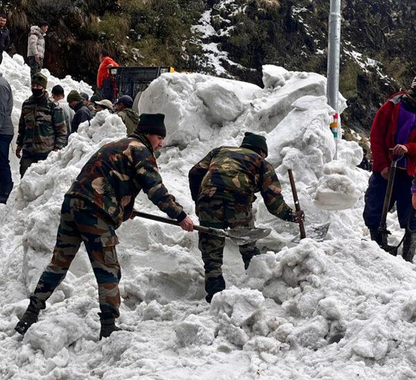 Soldiers clear snow from an avalanche near Nathu La mountain pass in India's Sikkim state on April 4, 2023. (Indian Army via AP)