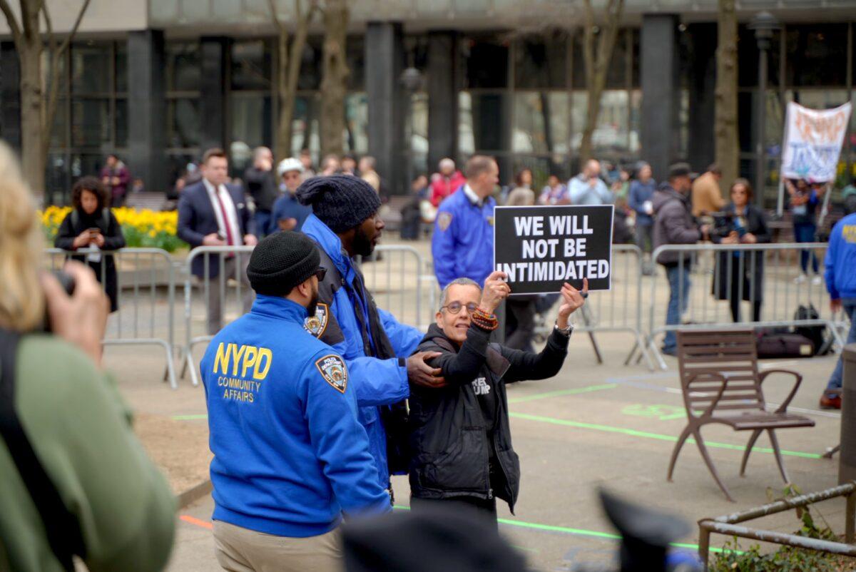 Protesters outside the New York County Criminal Court ahead of former President Donald Trump's arraignment on April 4, 2023. (The Epoch Times)