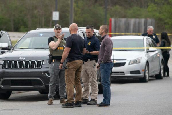 Knox County Sheriff's Office and FBI officers work in a parking lot area in Knoxville, Tenn., on April 3, 2023. (Saul Young/Knoxville News Sentinel via AP)
