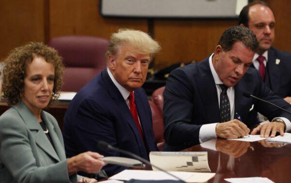 Former U.S. President Donald Trump is accompanied by members of his legal team, Susan Necheles and Joe Tacopina, as he appears in court for an arraignment on charges stemming from his indictment by a Manhattan grand jury, in New York City on April 4, 2023. (Andrew Kelly/Reuters)