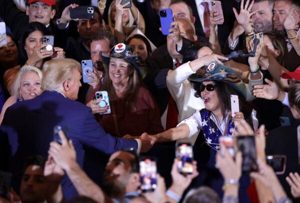 Former U.S. President Donald Trump (L) greets supporters during an event at Mar-a-Lago in West Palm Beach, Fla., on April 4, 2023. (Alex Wong/Getty Images)