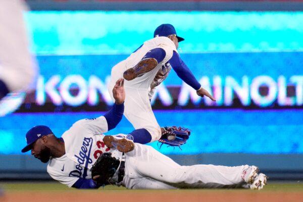 Los Angeles Dodgers second baseman Mookie Betts, top, collides with right fielder Jason Heyward as Betts made a catch on a fly ball by Colorado Rockies' Alan Trejo during the seventh inning of a baseball game in Los Angeles on April 4, 2023. (Marcio Jose Sanchez/AP Photo)