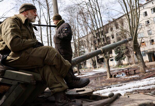 Ukrainian servicemen atop a tank near the bombed-out eastern city of Bakhmut, in the eastern Donetsk region of Ukraine, on April 2, 2023. (Violeta Santos Moura/Reuters)