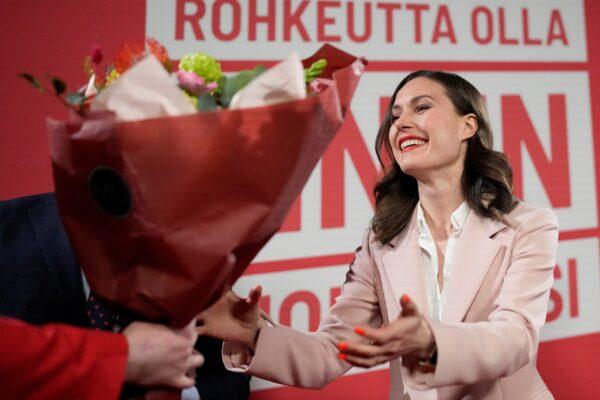 Finnish Prime Minister Sanna Marin presented flowers during an election party in Helsinki on April 2, 2023. (Sergei Grits/AP Photo)