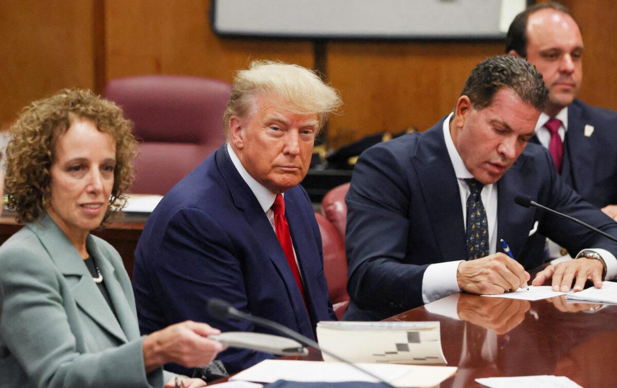 Former President Donald Trump is accompanied by members of his legal team, Susan Necheles and Joe Tacopina, as he appears in court for an arraignment on charges stemming from his indictment by a Manhattan grand jury, in New York City on April 4, 2023. (Andrew Kelly/Reuters)