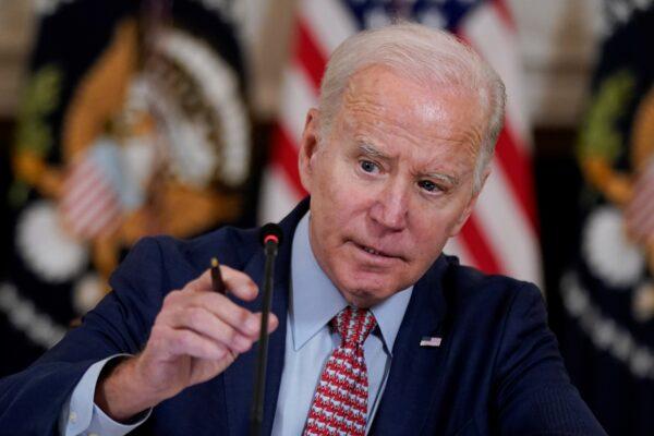 President Joe Biden adjusts his microphone during a meeting with the President's Council of Advisers on Science and Technology in the State Dining Room of the White House, in Washington on April 4, 2023. (Patrick Semansky/ AP Photo)