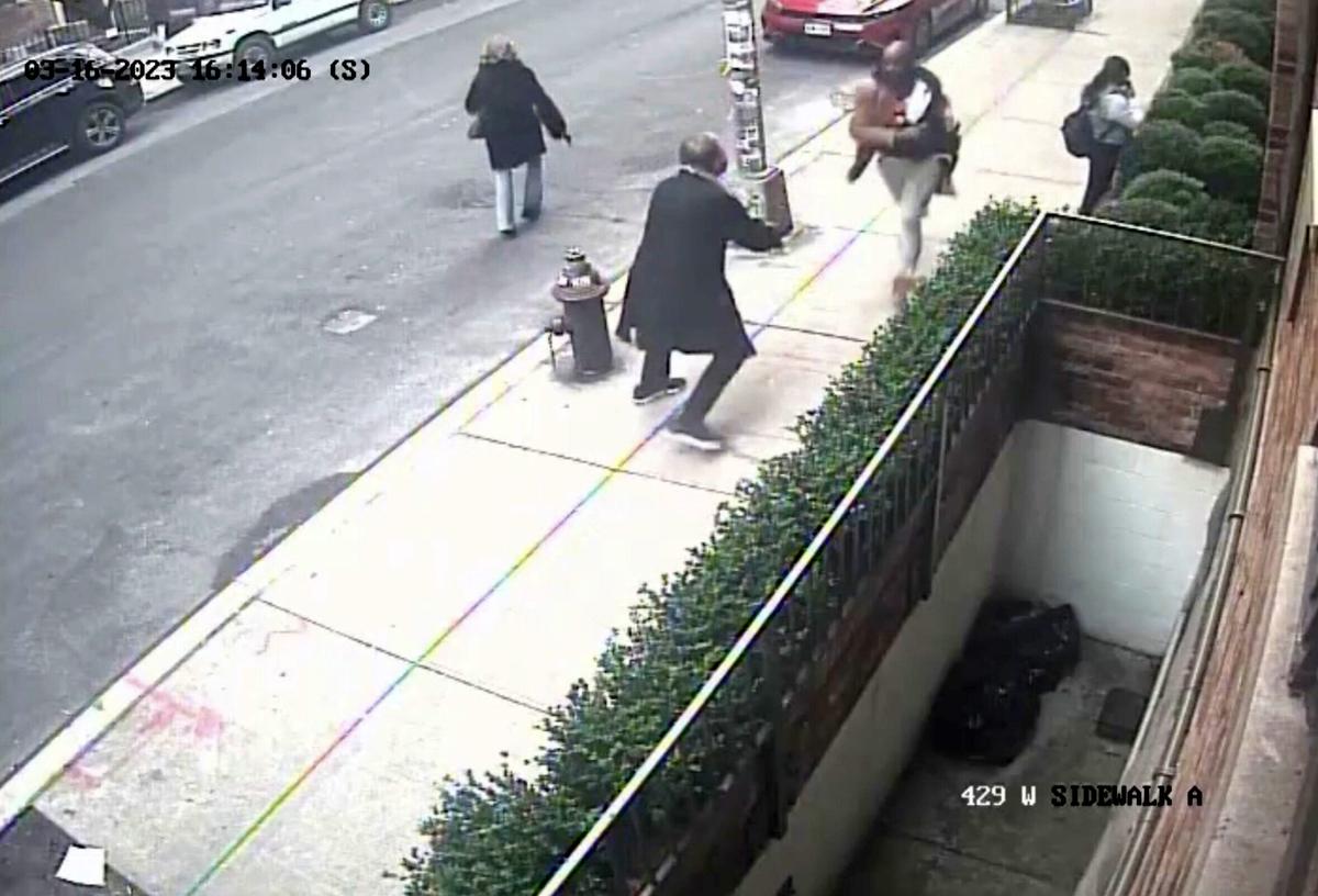 An armed suspect fleeing police is captured in security camera footage in Chelsey, Manhattan, New York, on March 16. (Screenshot/Newsflare)