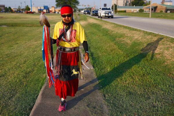 Seraphine Warren walks on her "Trailing Ella Mae Prayer Walk" for murdered and missing indigenous people in Catoosa, Okla., on Aug. 5, 2022. (Mike Simons/Tulsa World via AP)