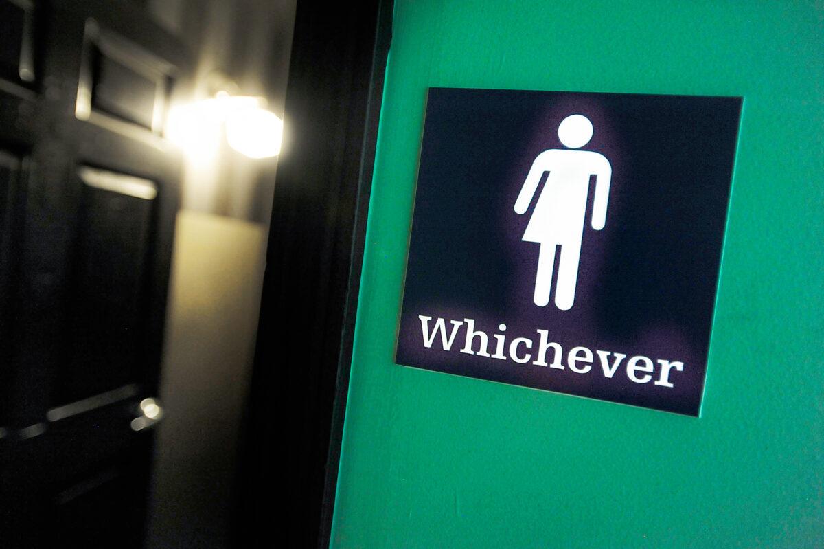 A gender-neutral sign is posted outside a restroom at Oval Park Grill in Durham, N.C., on May 11, 2016. (Sara D. Davis/Getty Images)