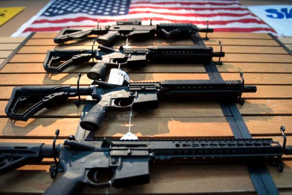 Assault rifles hang on the wall for sale at Blue Ridge Arsenal in Chantilly, Virginia, on October 6, 2017. (JIM WATSON/AFP via Getty Images)