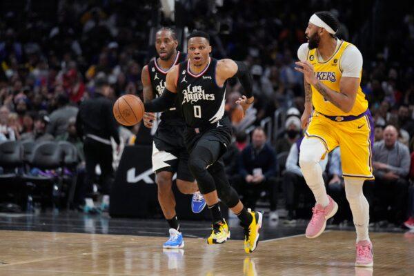 Los Angeles Clippers guard Russell Westbrook (0) dribbles the ball past Los Angeles Lakers forward Anthony Davis (R), during the second half of an NBA basketball game in Los Angeles on April 5, 2023. (Marcio Jose Sanchez/AP Photo)