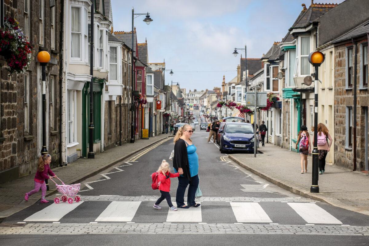 A woman uses a pedestrian crossing in Camborne, Cornwall, England, on July 24, 2017. (Matt Cardy/Getty Images)